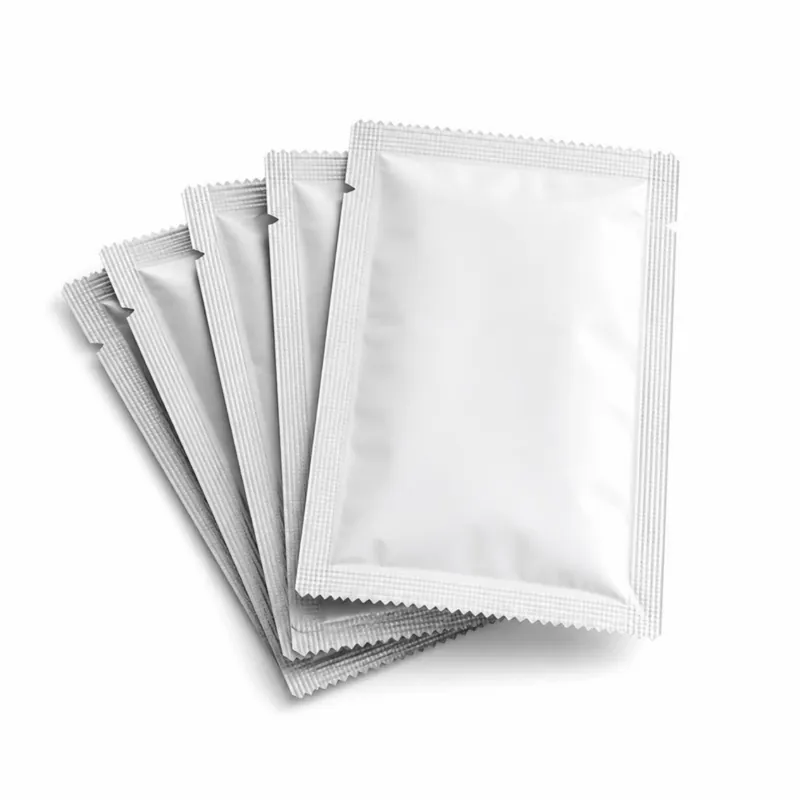 Fanned stack of blank white sachets with serrated sealed edges